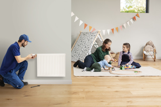 working installer and a family playing in the background