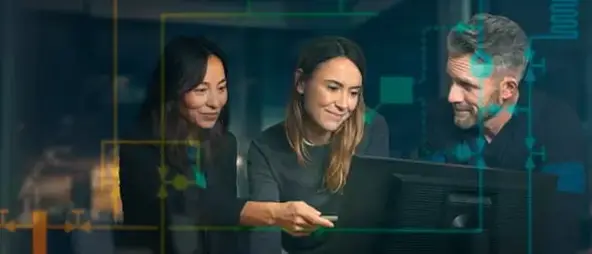 Team of 3 people glancing at a computer screen on how to install indoor climate
