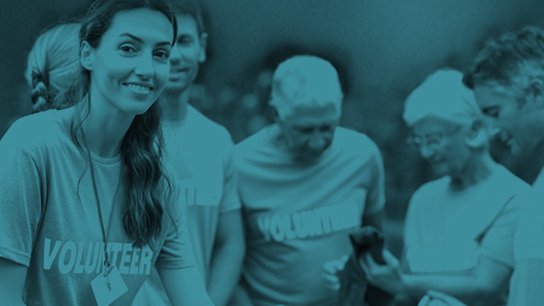 A group of people wearing t-shirts with the word "volunteer" on them
